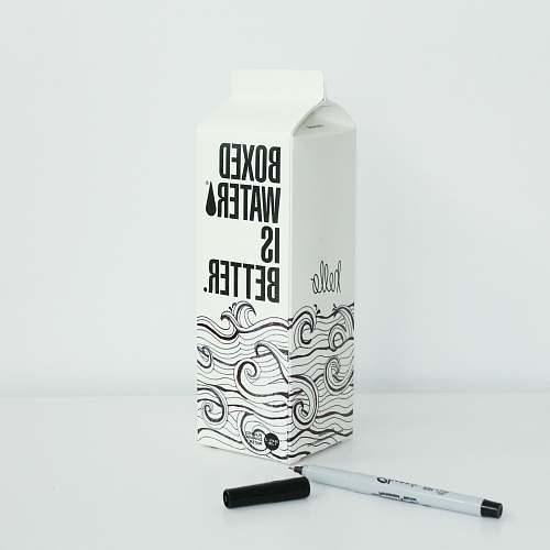 grey Boxed water is Better carton with waves drawn on it with a sharpie 